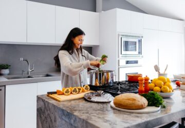 woman smiling while cooking