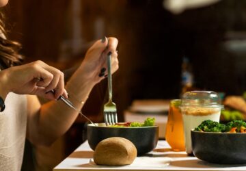 person holding silver fork and knife